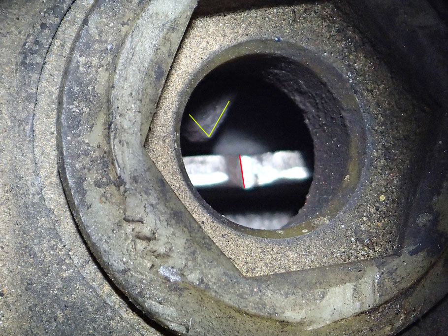 This viewing hole is between the engine and transmission. When the arrow  (yellow) points to the middle of the notch (red), the crank shaft is at top dead center. The arrow points left of the notch, so we need to align the crank shaft with the cam shaft.