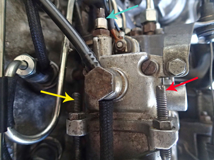 Smoke screw (green arrow) on the injection pump! The Yellow points to the idle speed screw, and red points to the max RPM screw.