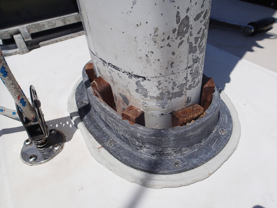 Bolts are tightened down; butyl has oozed out; Wedges are driven in to secure the mast in place.