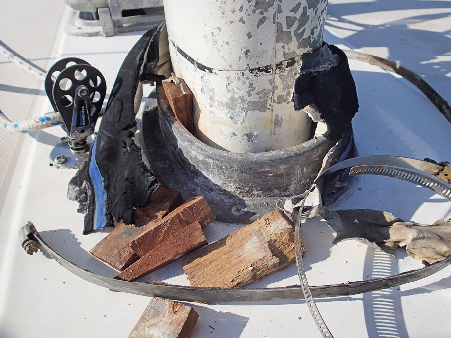 We also had leaks around our mast. Here we see how it looks under the mast "boot". Our mast goes through the deck and is stepped below at the top of the keel. On the deck is a metal collar. Wooden wedges are driven between the mast and collar. Then the collar is covered with a mast boot to keep water out.